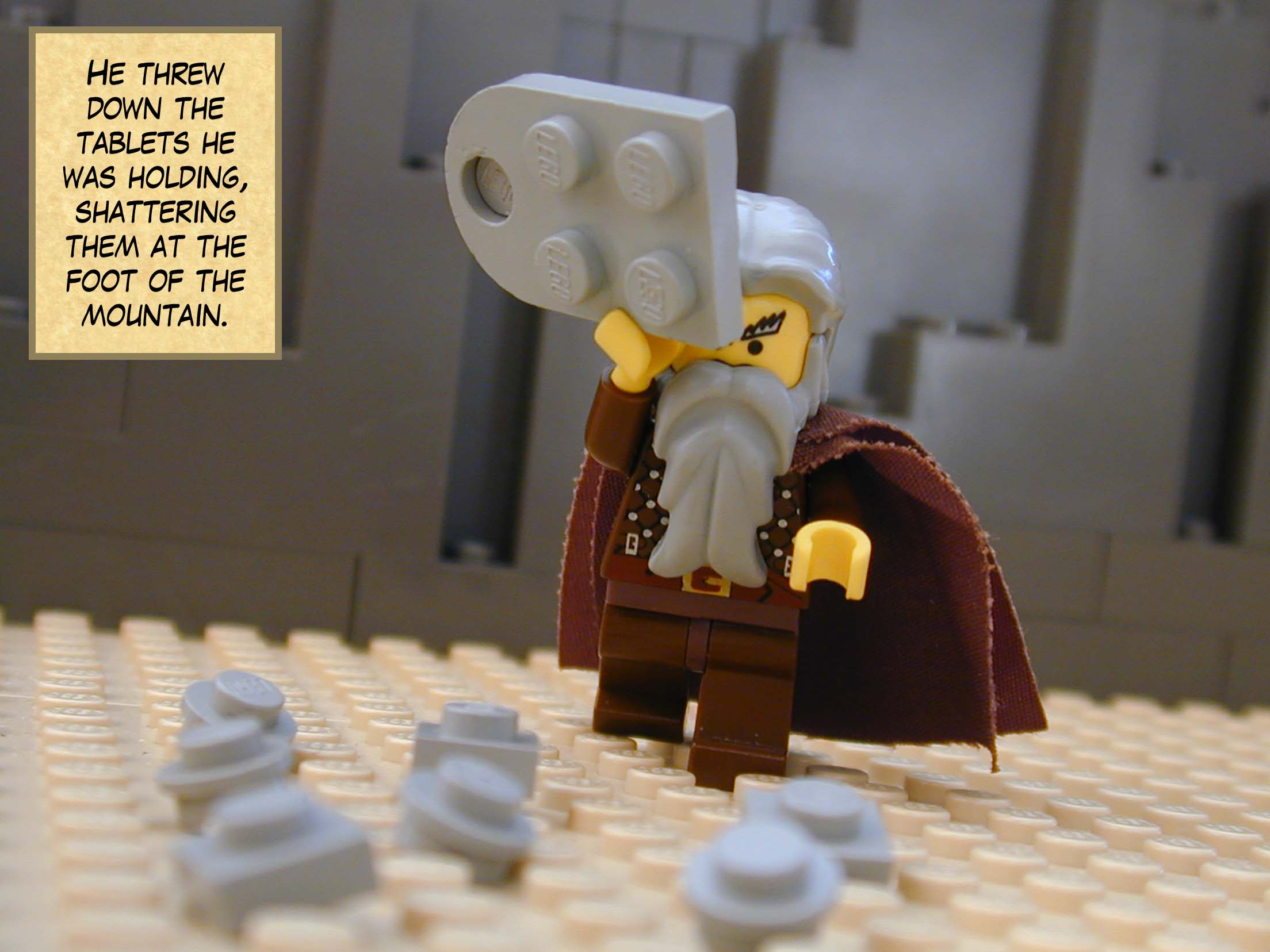 He threw down the tablets he was holding, shattering them at the foot of the mountain.
